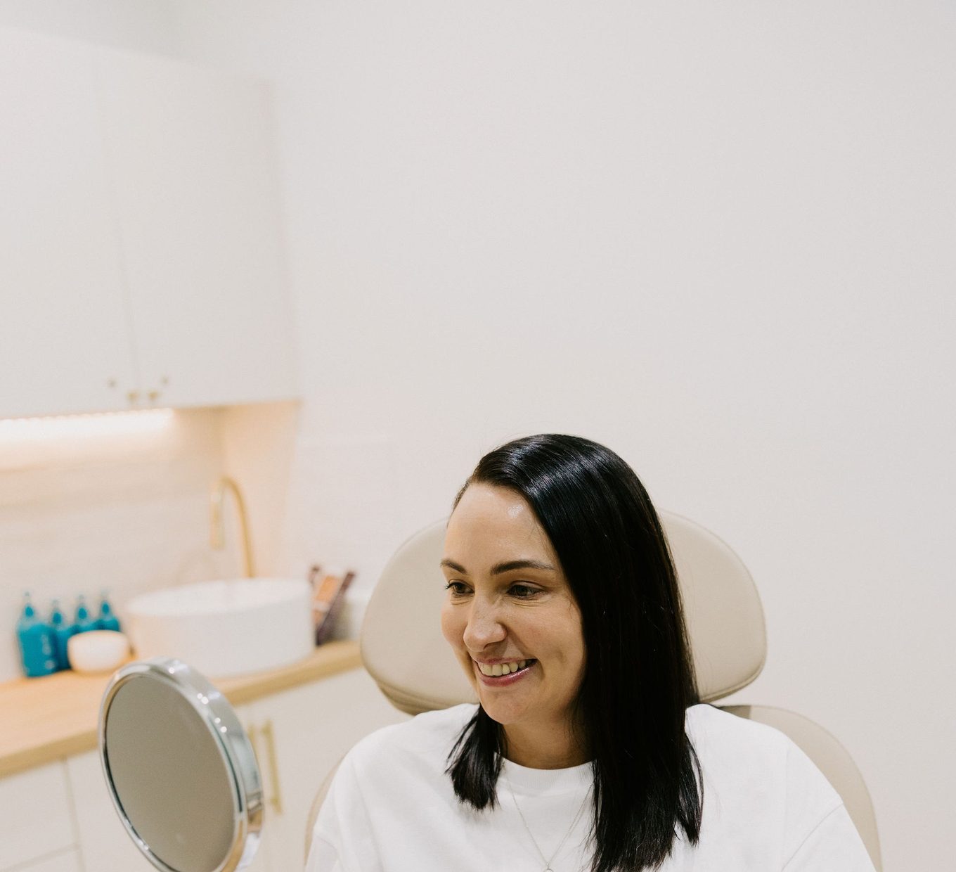 A patient seated in the treatment chair at Bloom Aesthetic Clinic during an assessment.