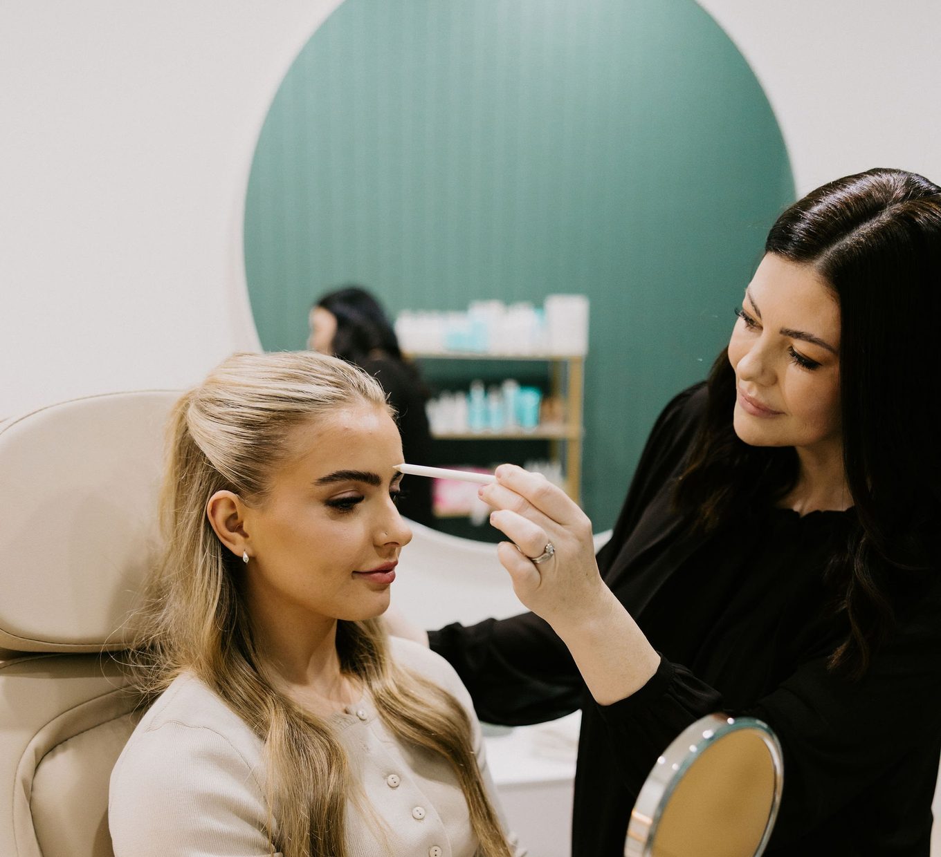 Sarah Munnings assessing a patient’s skin ahead of a microneedling course.