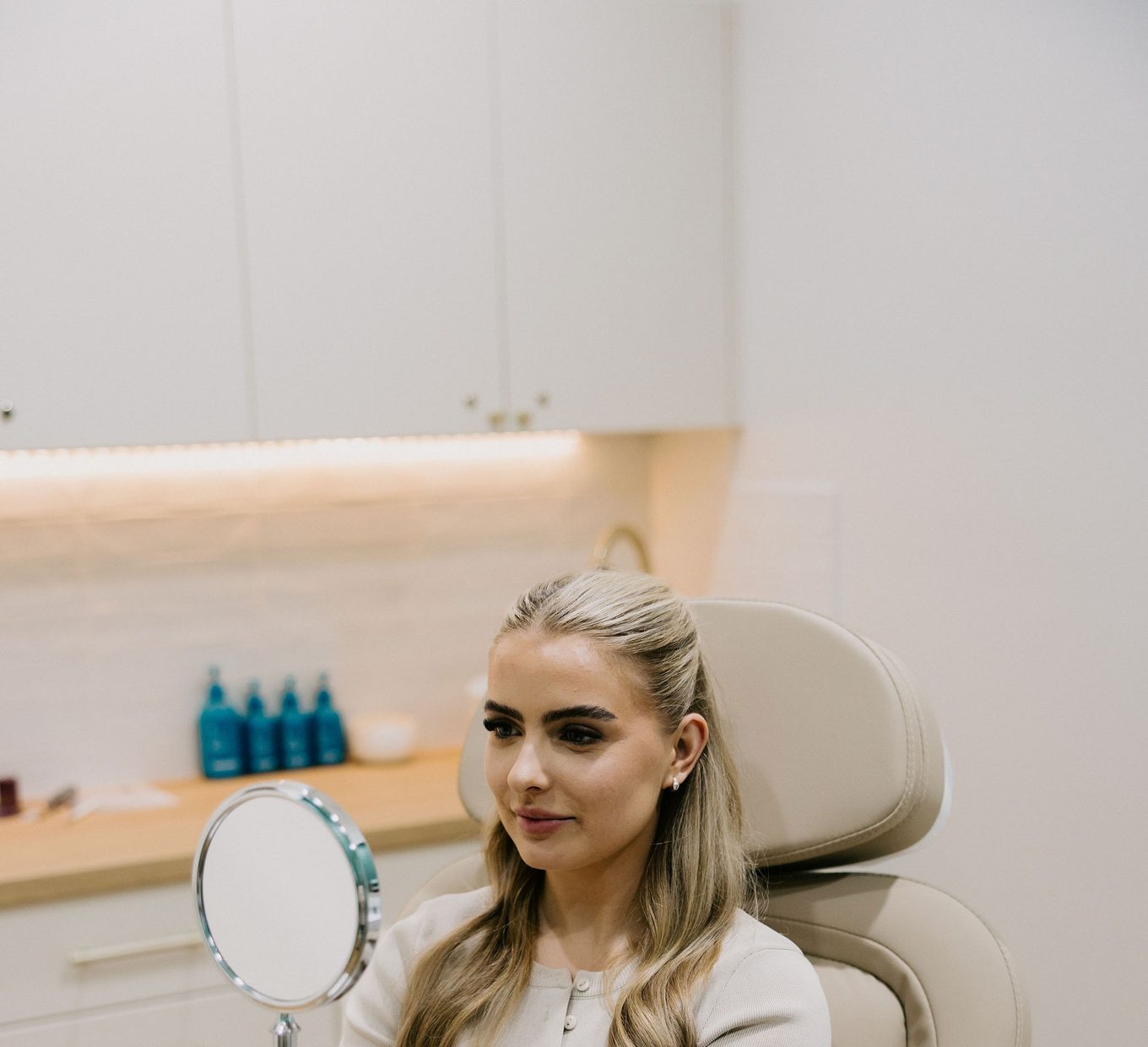 A patient seated in the treatment chair during a consultation at Bloom Aesthetic Clinic.