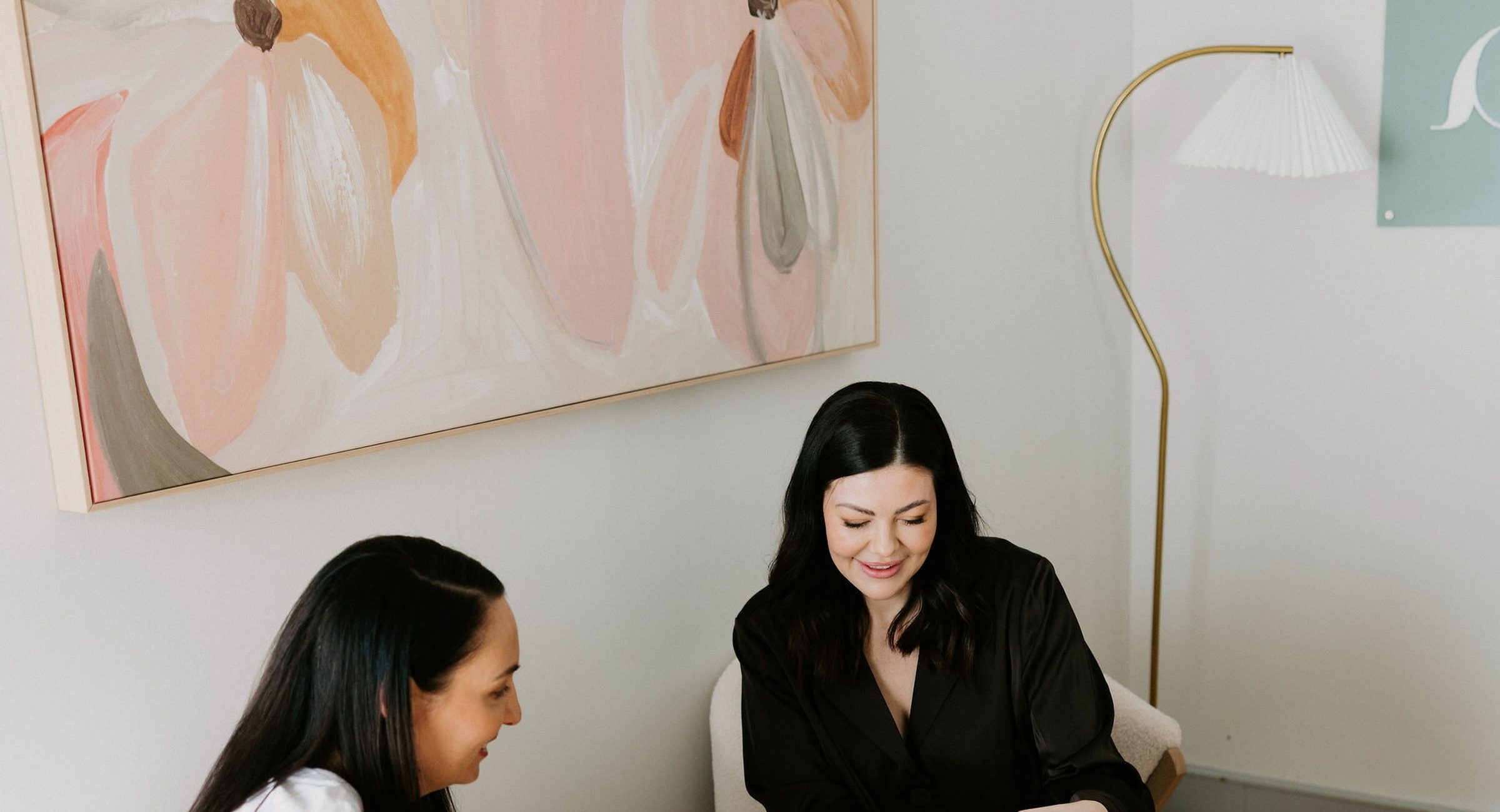 Sarah Munnings and a patient seated together in the Bloom consultation lounge.