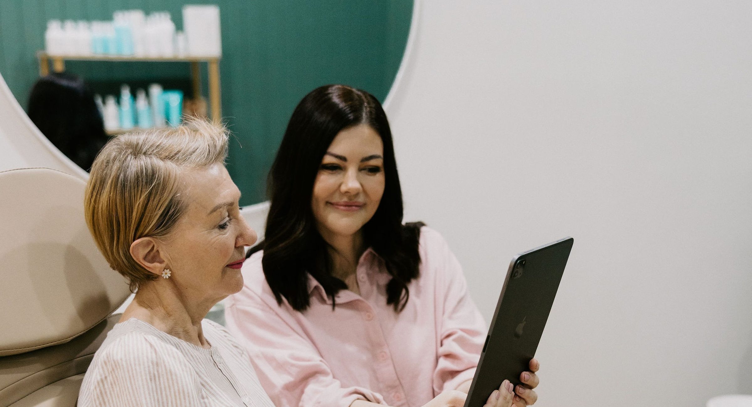 Sarah Munnings going through information on a tablet with a patient.